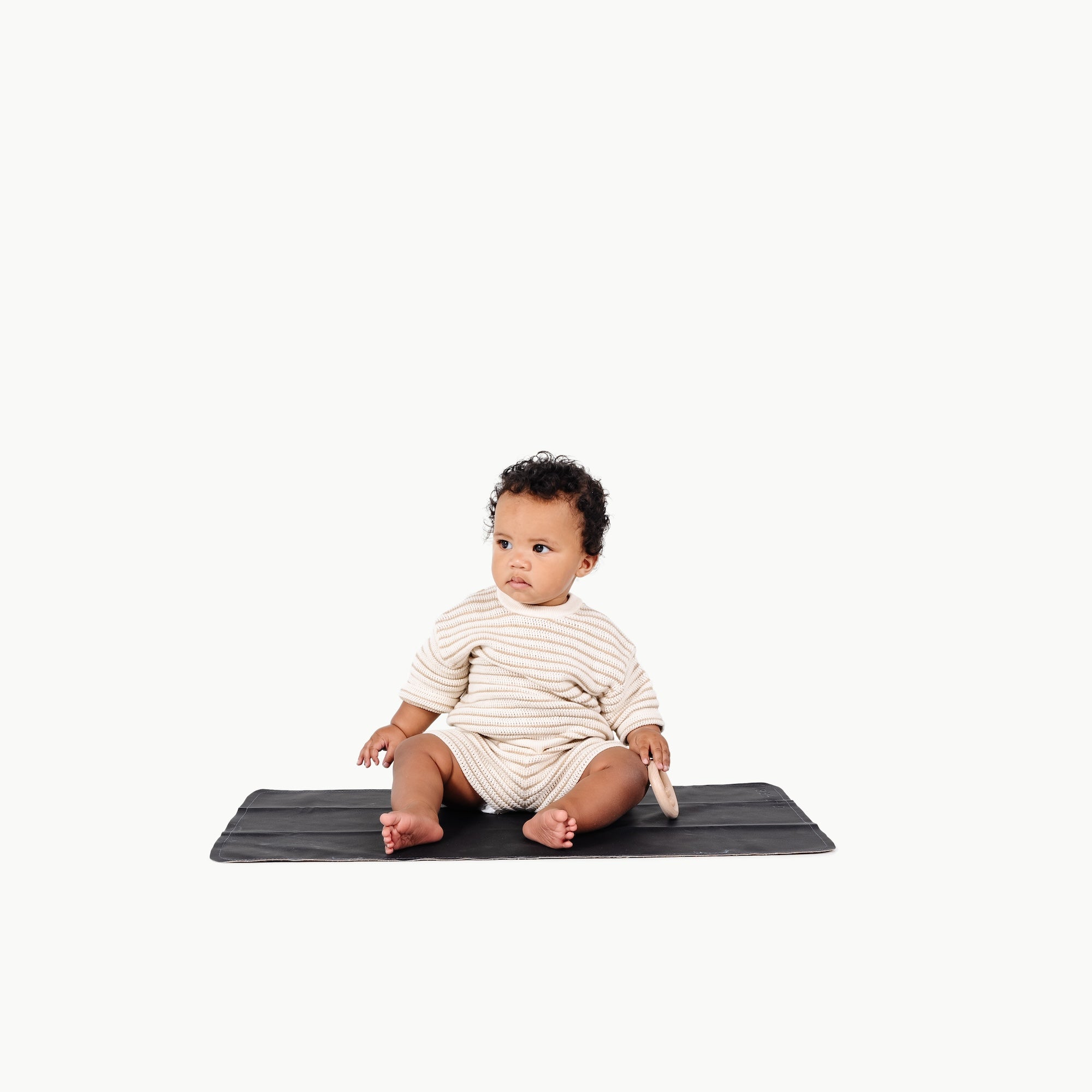 Raven (on sale)@baby sitting on the Raven Micro+ Mat