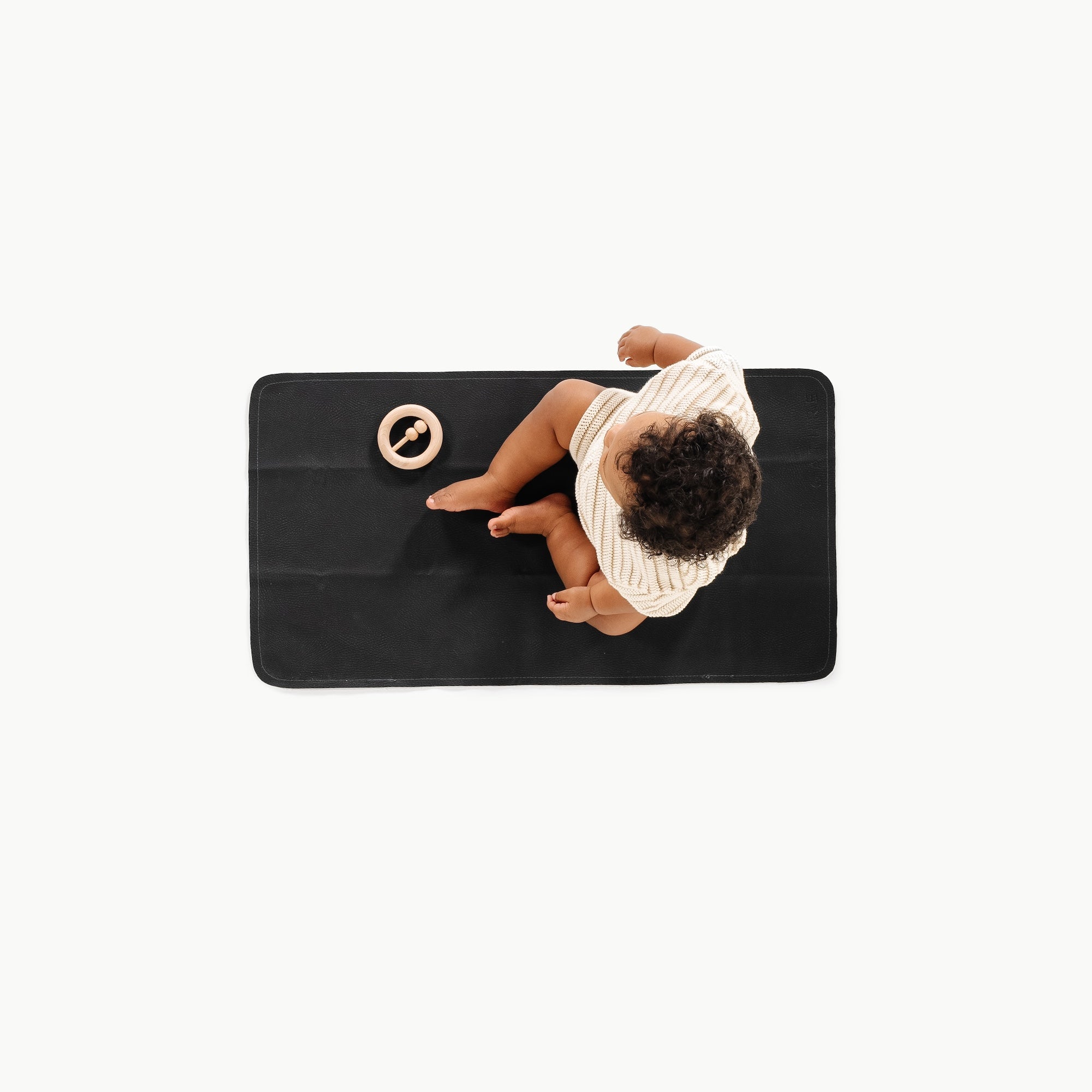 Raven (on sale)@Overhead baby sitting on the Raven Micro+ Mat