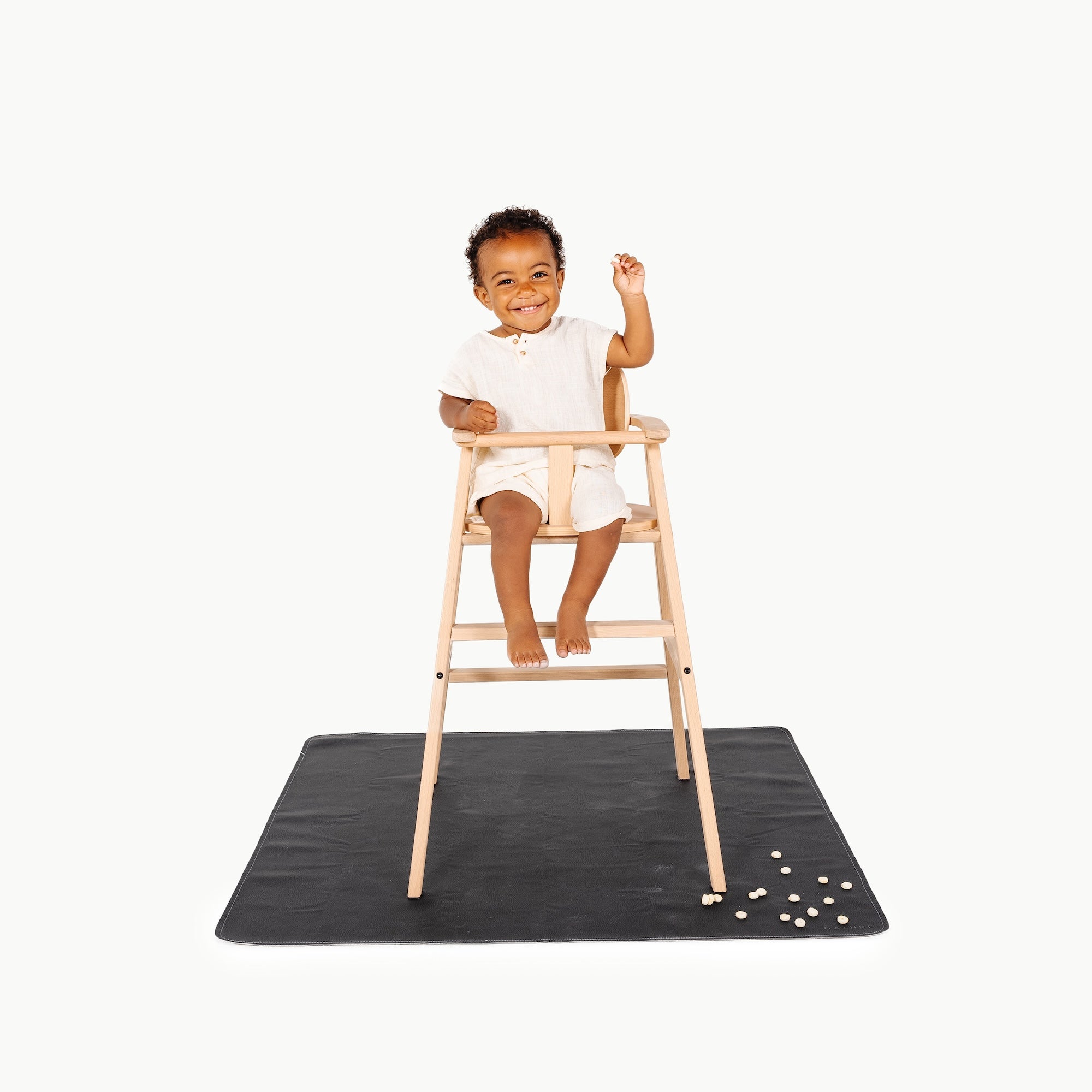 Raven@little boy in high chair on mini mat