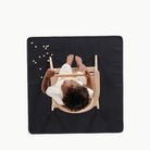 Raven@overhead of little boy in high chair on mini mat