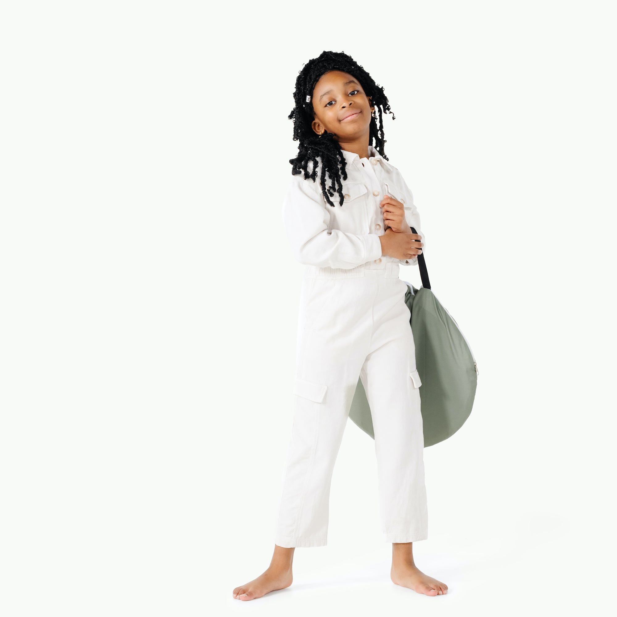 Seagrass@kids holding the rollic by gathre 3-in-1 playroom bundle folded up