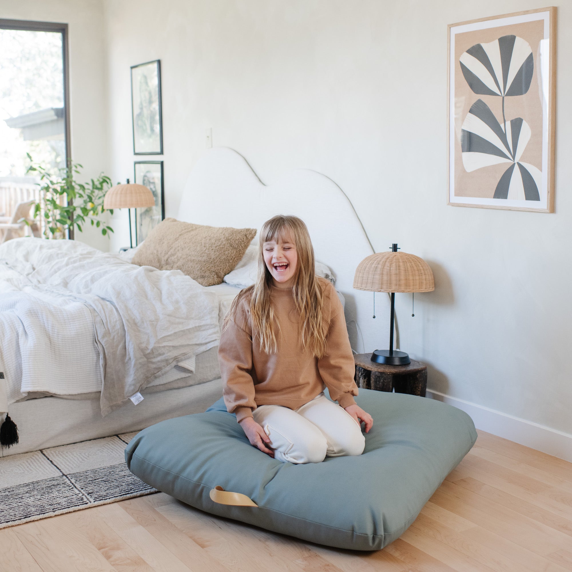 Amalfi (on sale)@lifestyle image of girl sitting on cushion