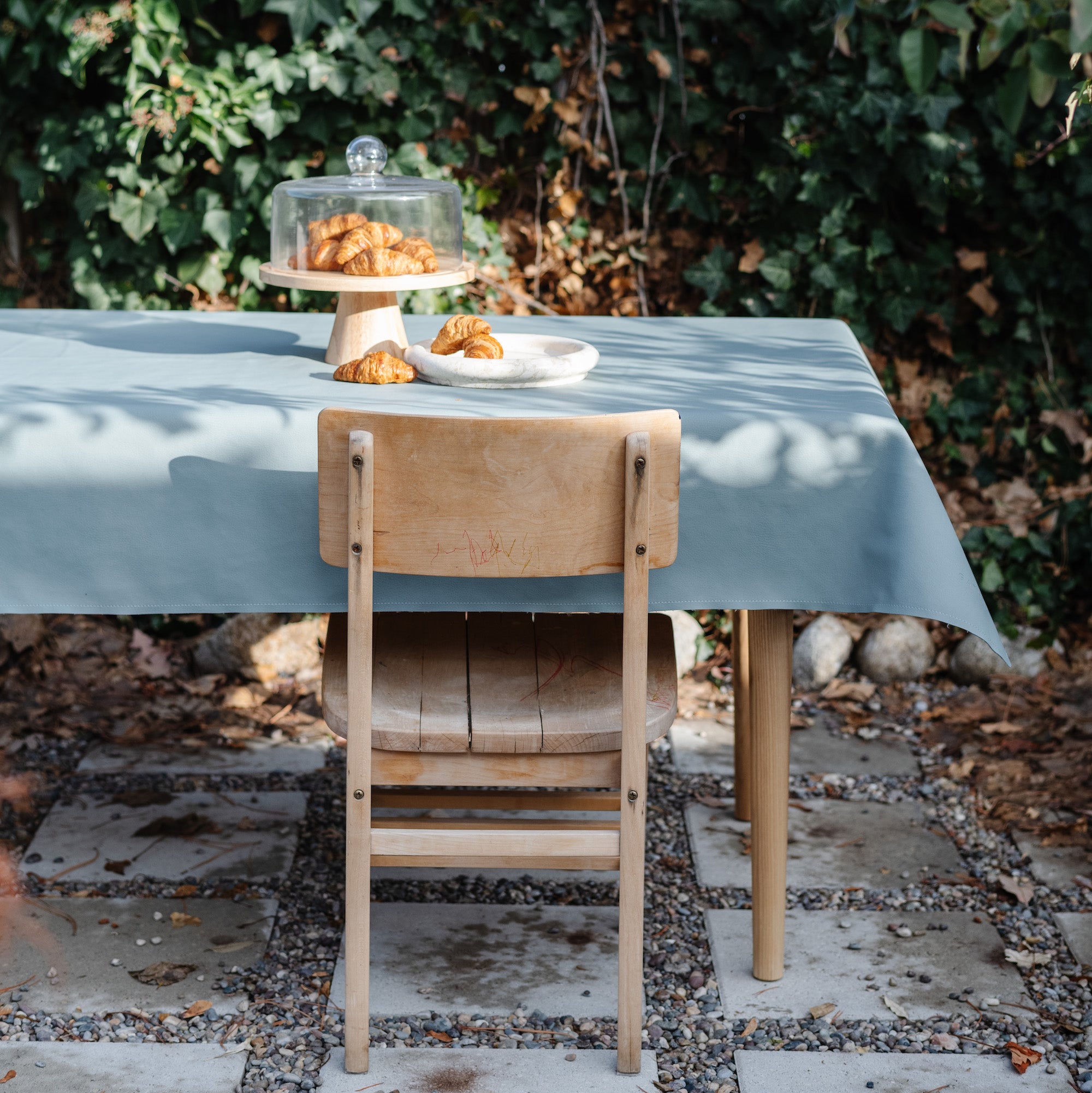 Amalfi / 6 Foot @Amalfi Tablecloth on a table outside near greenery