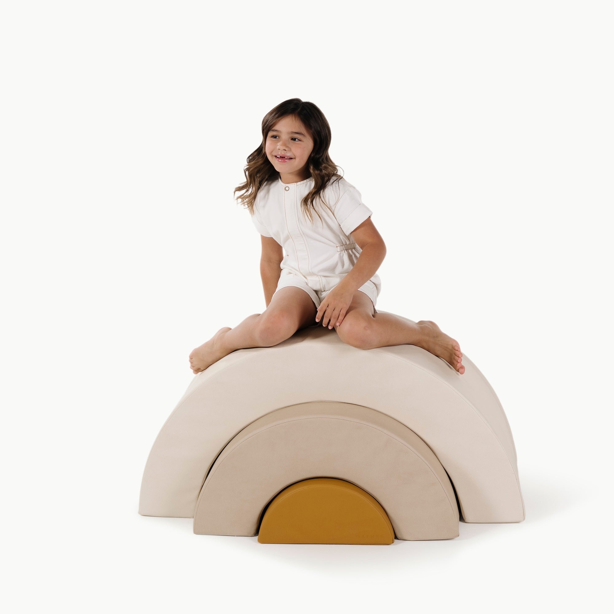 Ivory • Millet • Saffron@little girl playing on an arc playset