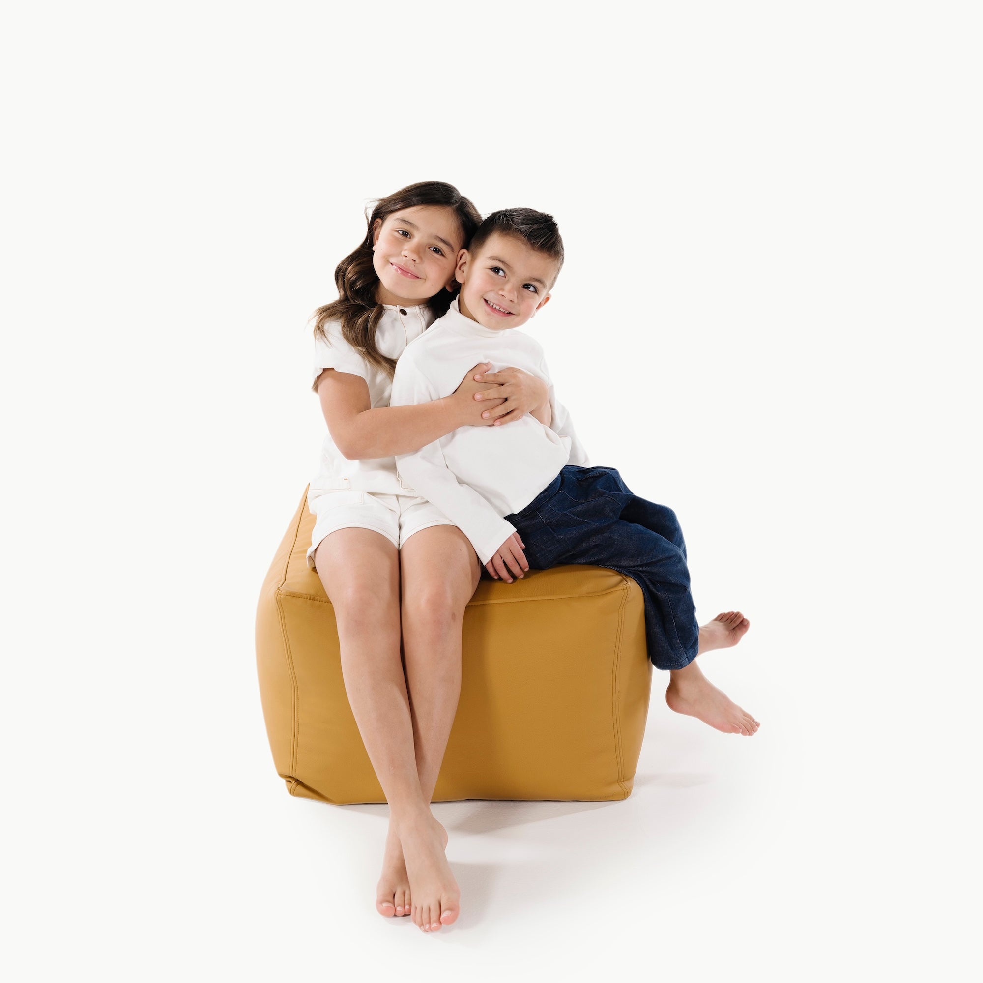 Saffron@kids sitting on square pouf