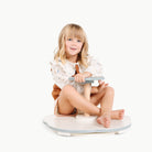 Harbor@girl sitting on the sit and spin toy