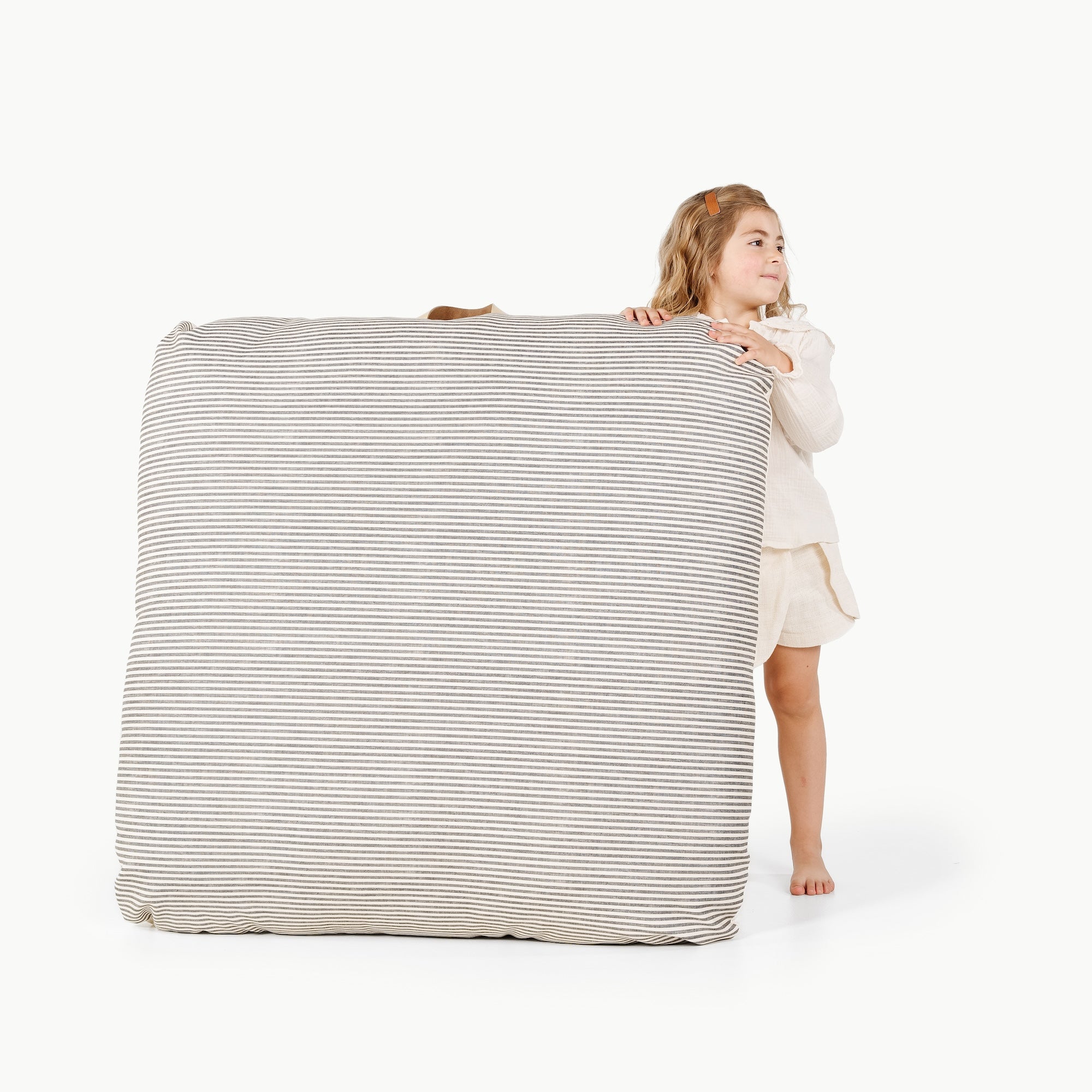 Stone Stripe / Square@Kid holding the Stone Stripe Square Floor Cushion