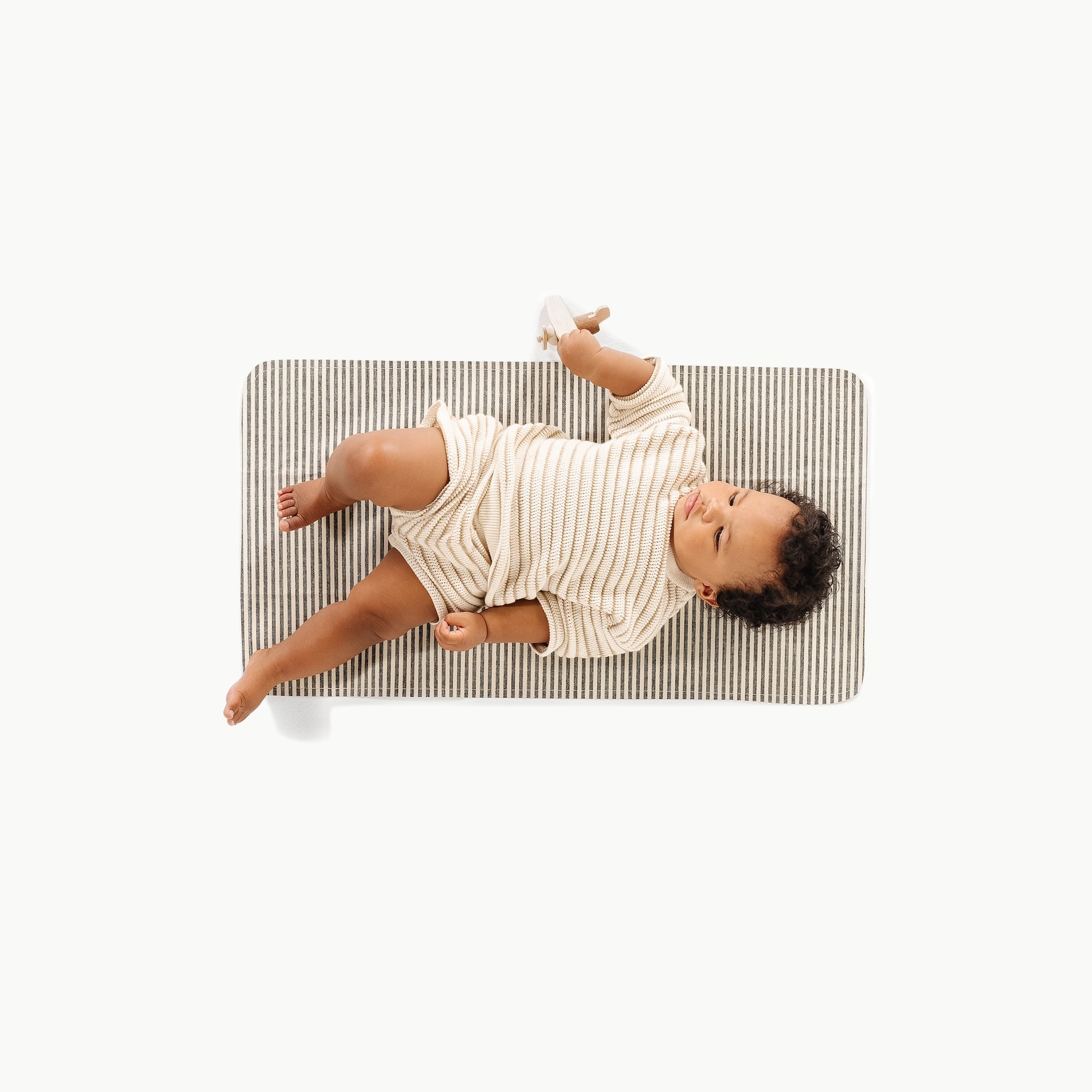 Stone Stripe@Overhead of Baby sitting on the Stone Stripe Micro+ Mat