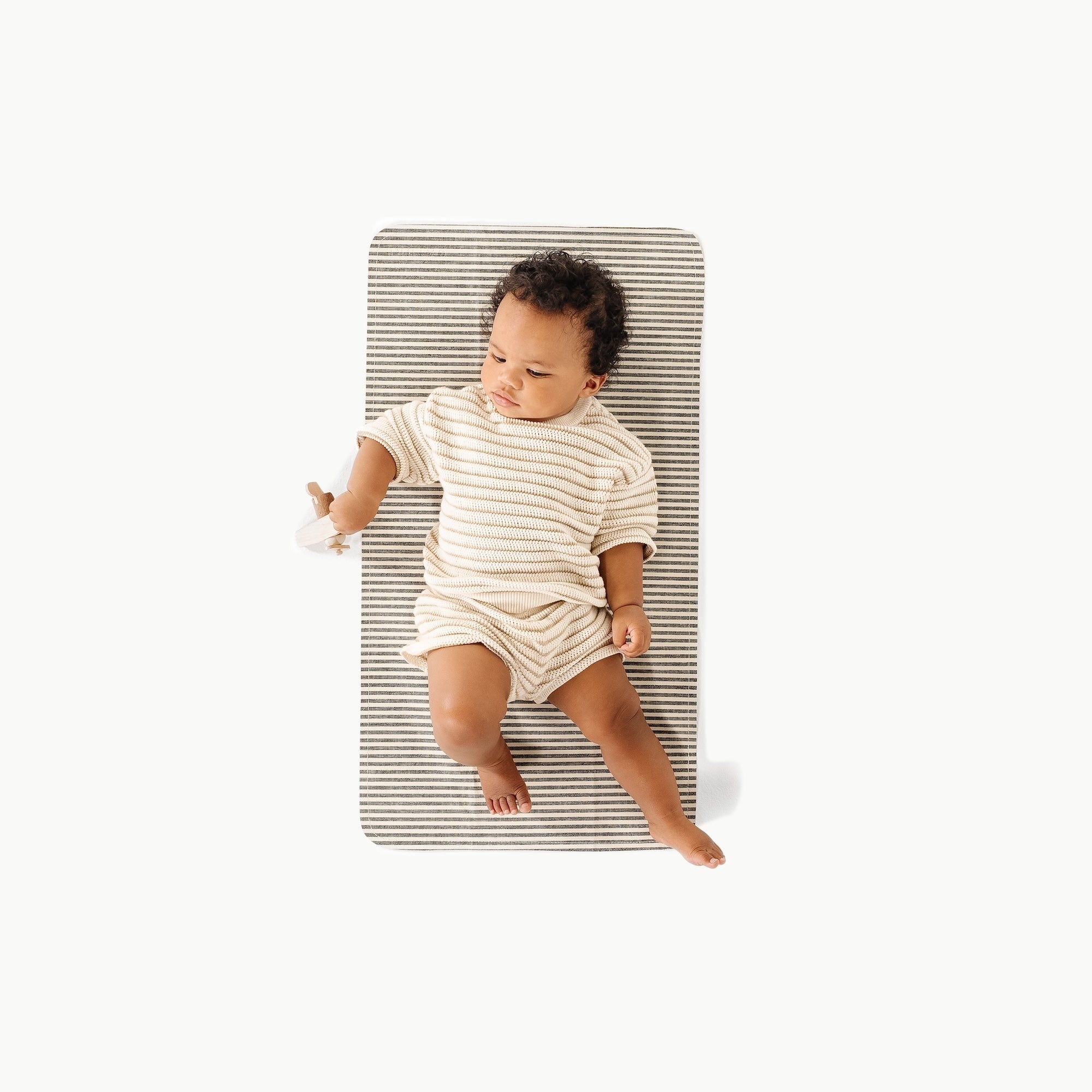 Stone Stripe / Micro+@ Micro+ (Color) overhead of a baby on the stone stripe micro+ mat