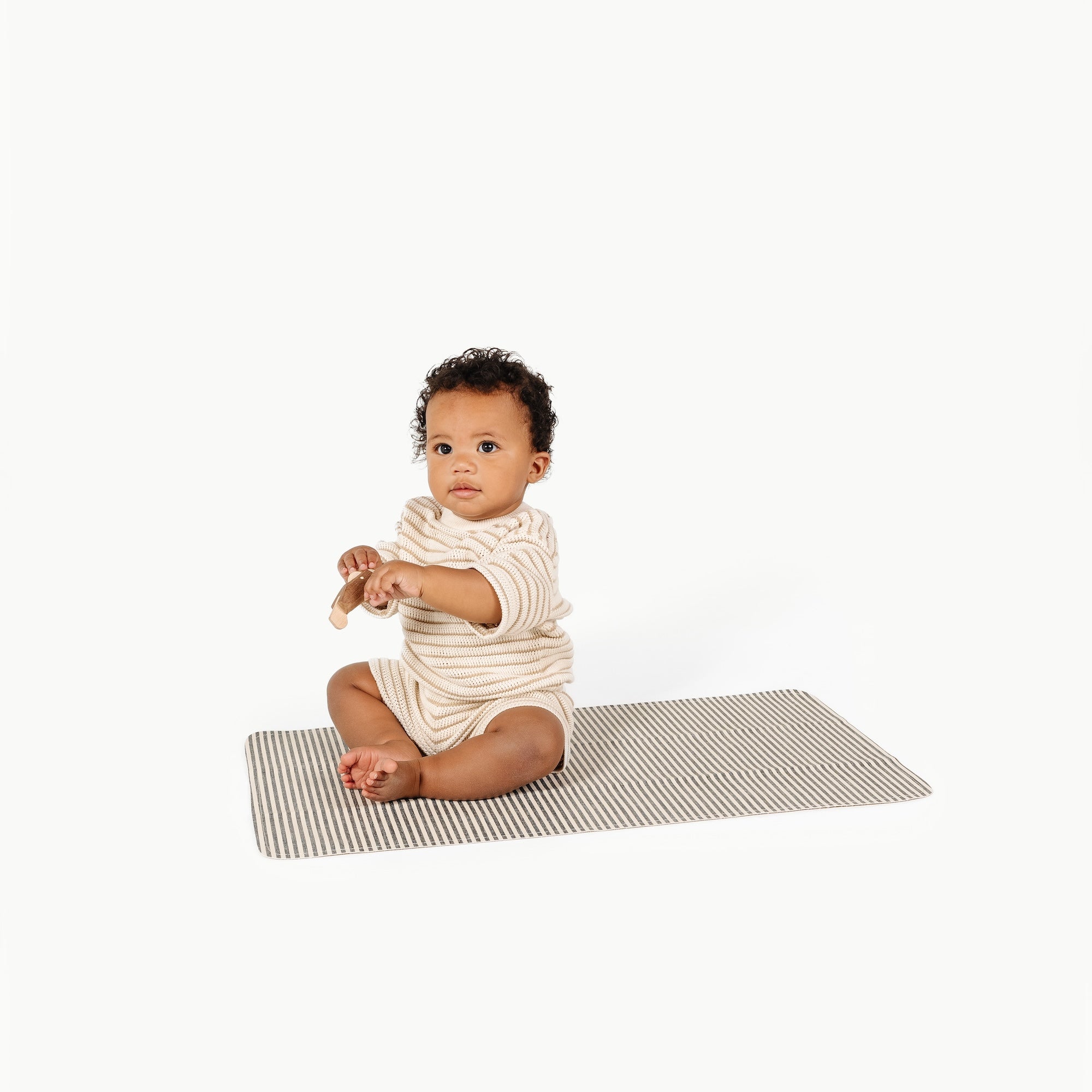 Stone Stripe@Baby sitting on the Stone Stripe Micro+ Mat