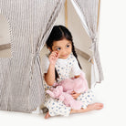 Stone Stripe@little girl sitting in the play tent