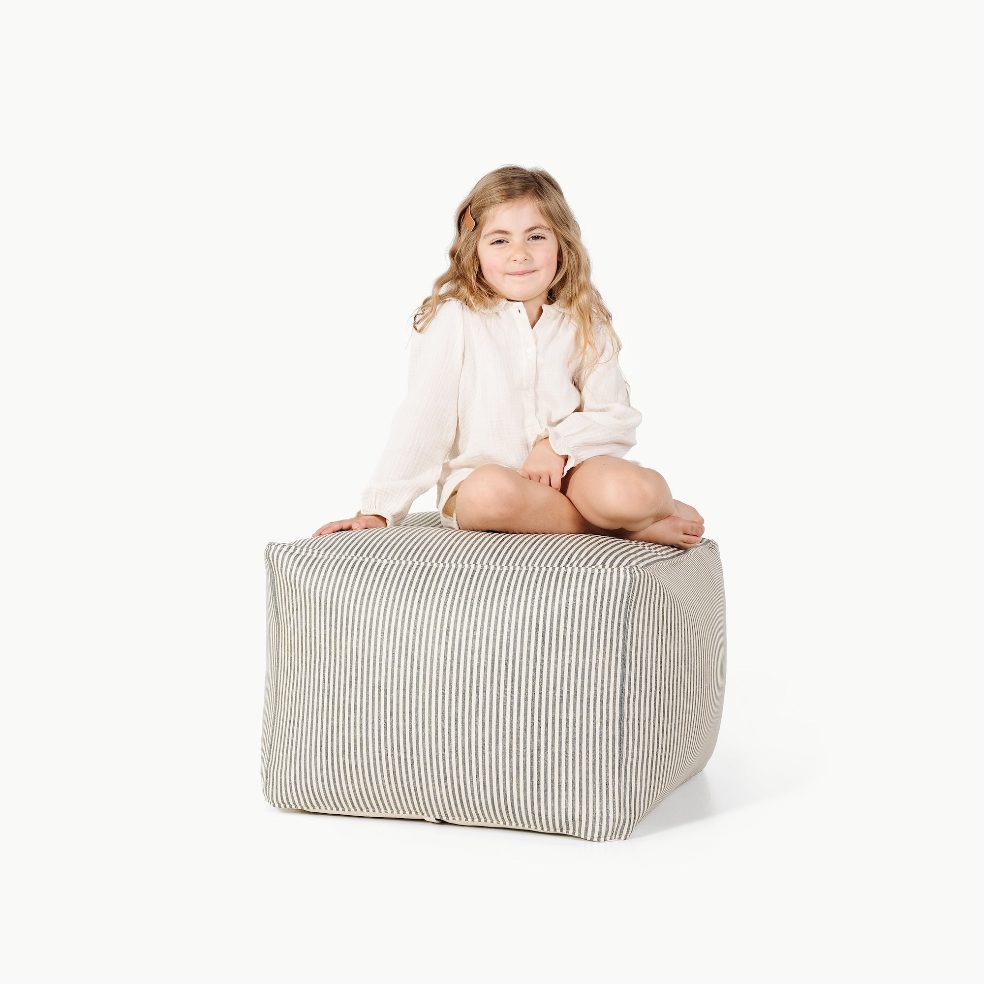 Stone Stripe@Little girl sitting on the Stone Stripe Square Pouf