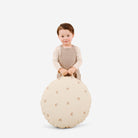 Tiny Rainbow (on sale) / Circle@kid holding the tiny rainbow mini circle floor cushion