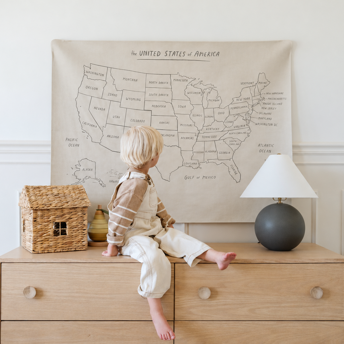 USA Map@kid sitting in front of the USA Map Mini+ Mat hanging on a wall