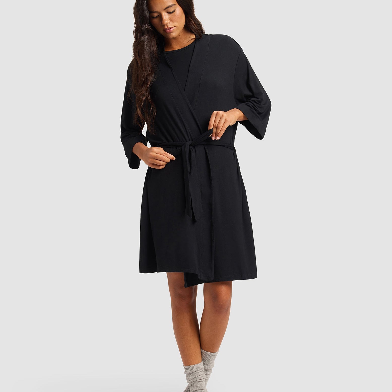 Black@woman wearing a black cozy earth robe