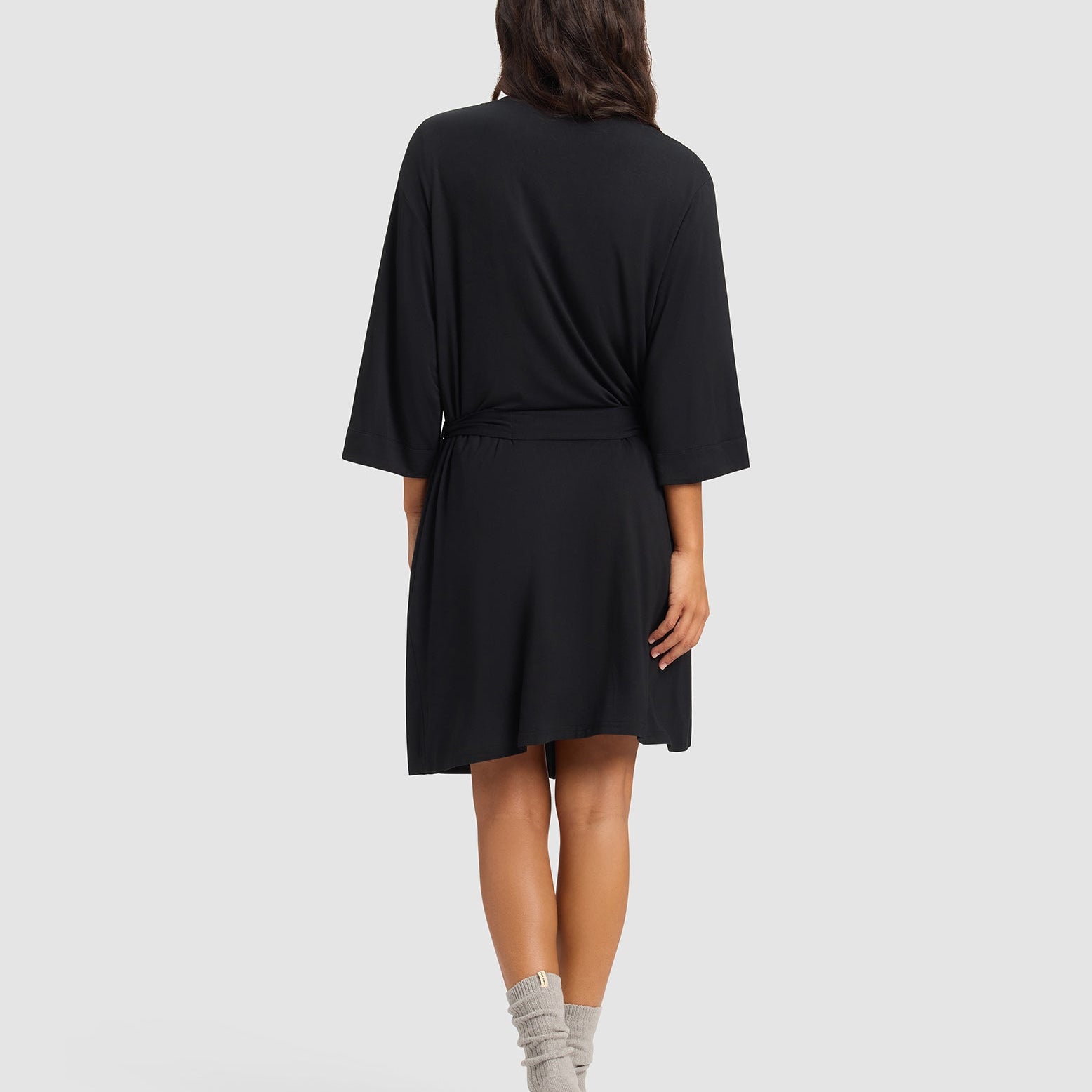 Black@woman wearing a black cozy earth robe