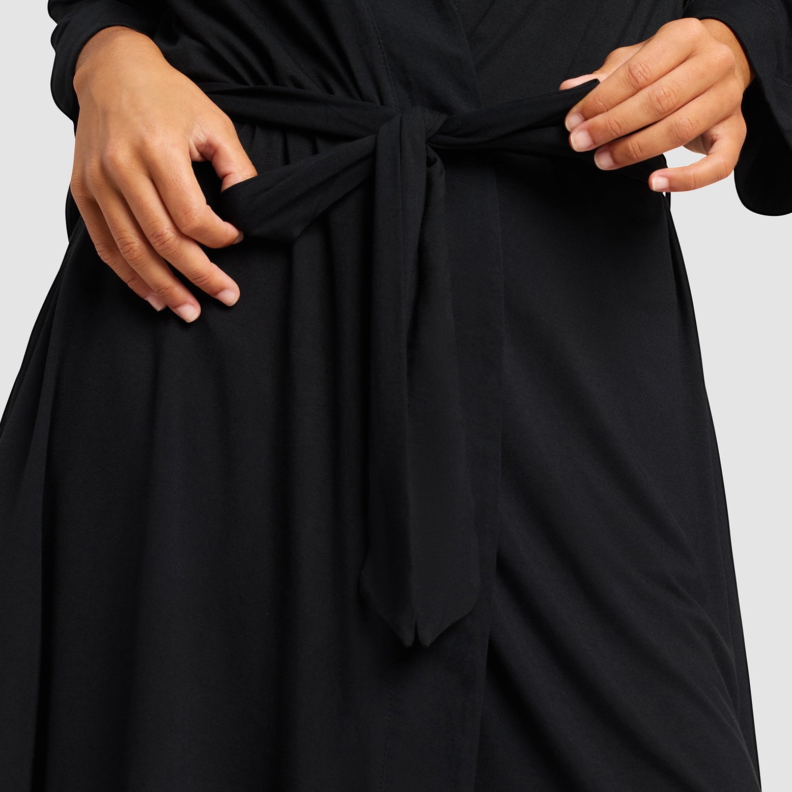 Black@woman wearing a black cozy earth robe