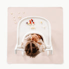 Belle@Overhead baby sitting in highchair on the Belle Mini Mat