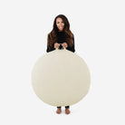 Blanc (on sale) / Circle@Woman holding the Blanc Circle Floor Cushion