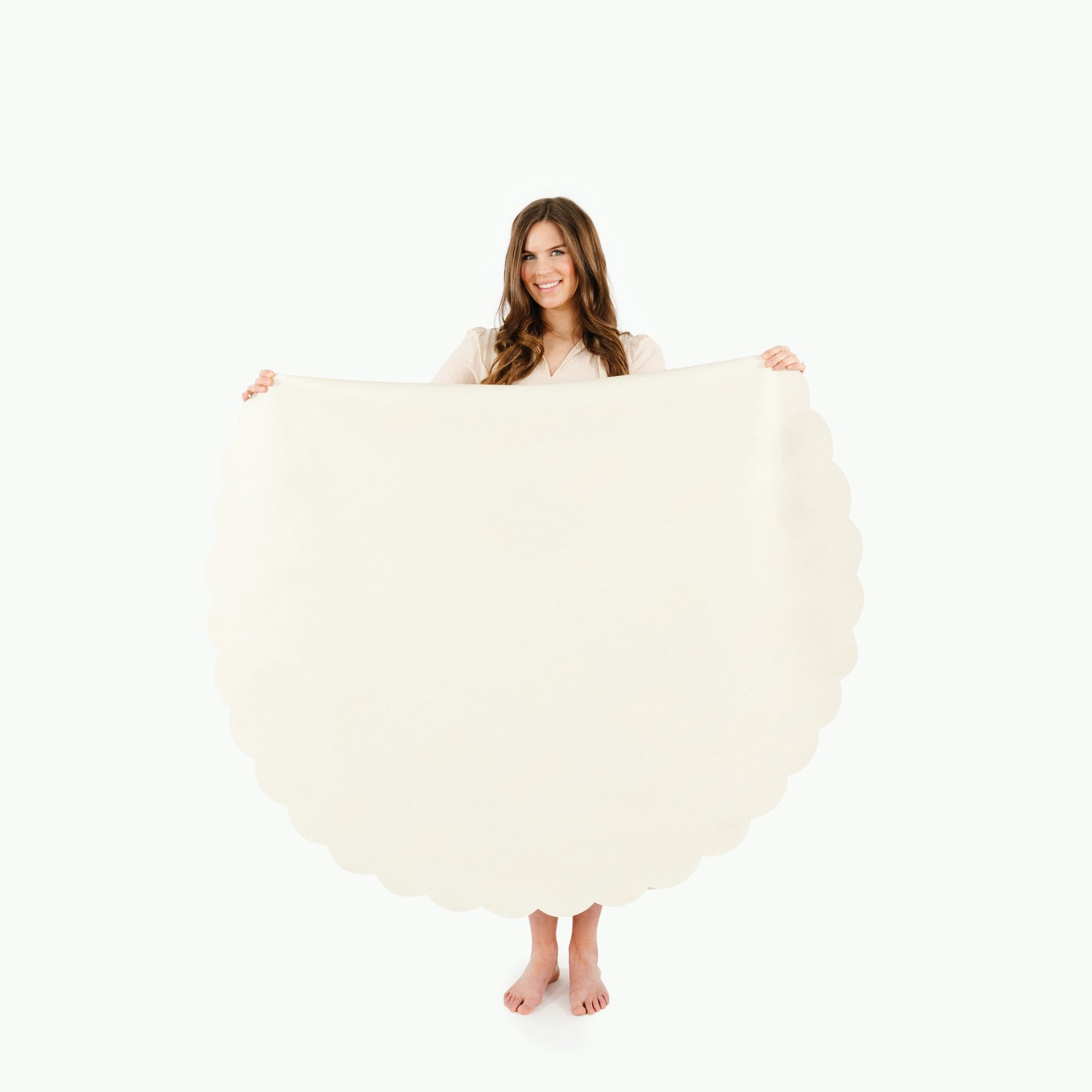 Ivory Scallop (on sale) / Circle@Woman holding the Ivory Scallop Circle Midi Mat