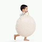 Bloom (on sale) / Circle@Kid holding the Bloom Circle Mini Floor Cushion