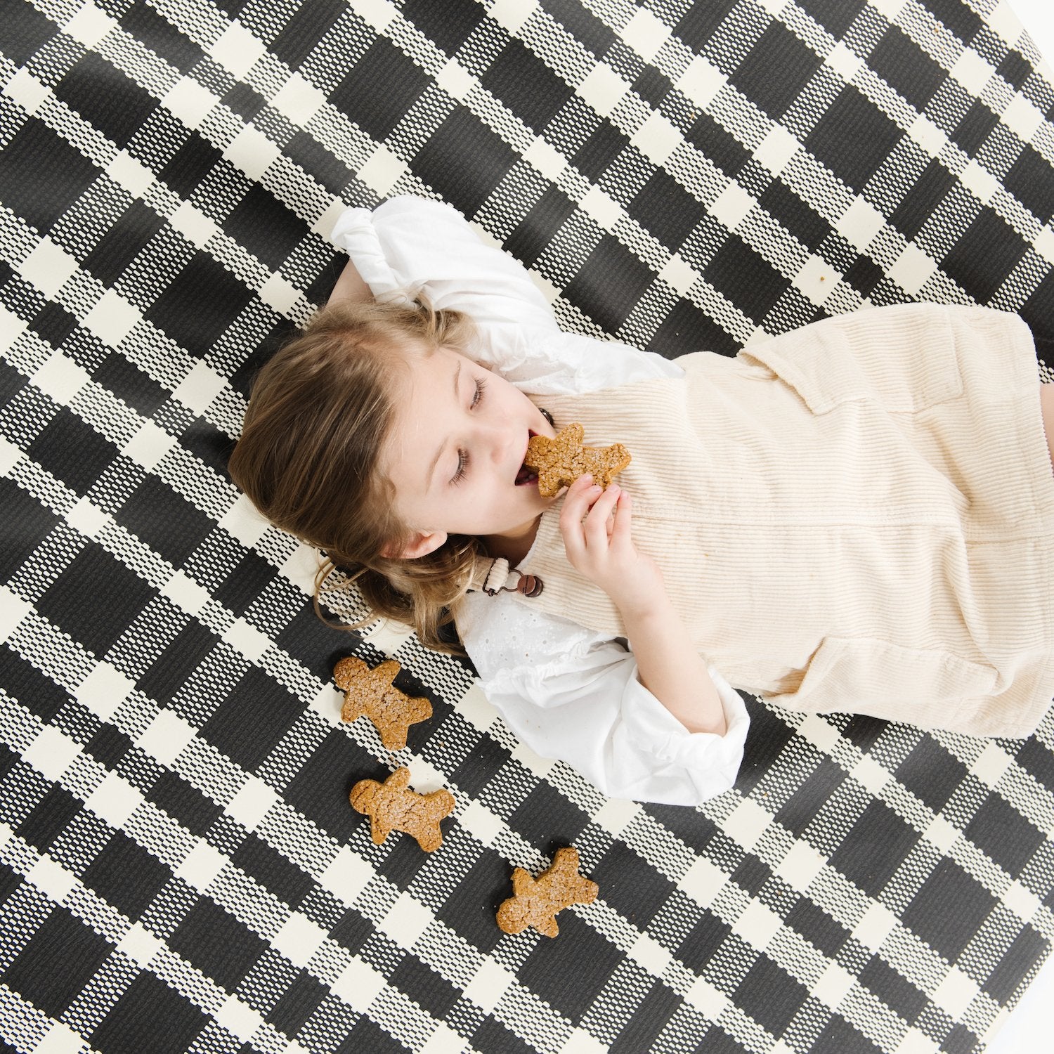 Onyx (on sale)@overhead of kid laying on the onyx padded midi circle