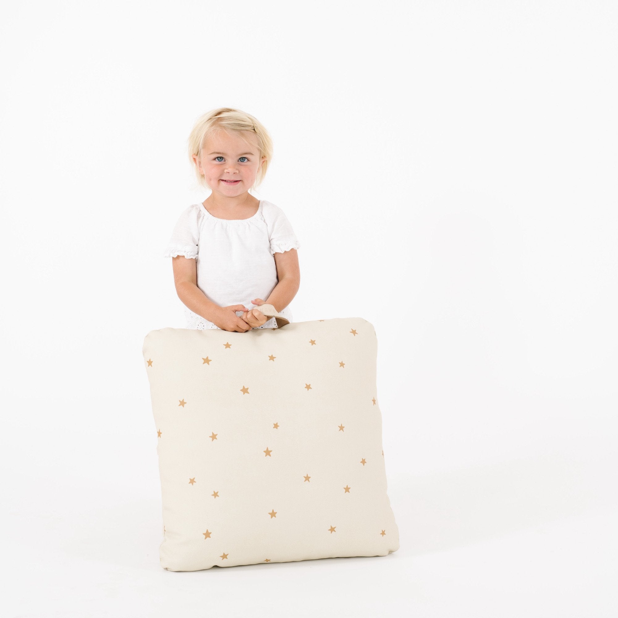 Stars (on sale) / Square@Kid holding a stars mini square floor cushion