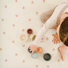 Tiny Rainbow (on sale)@kid playing on tiny rainbow tablecloth