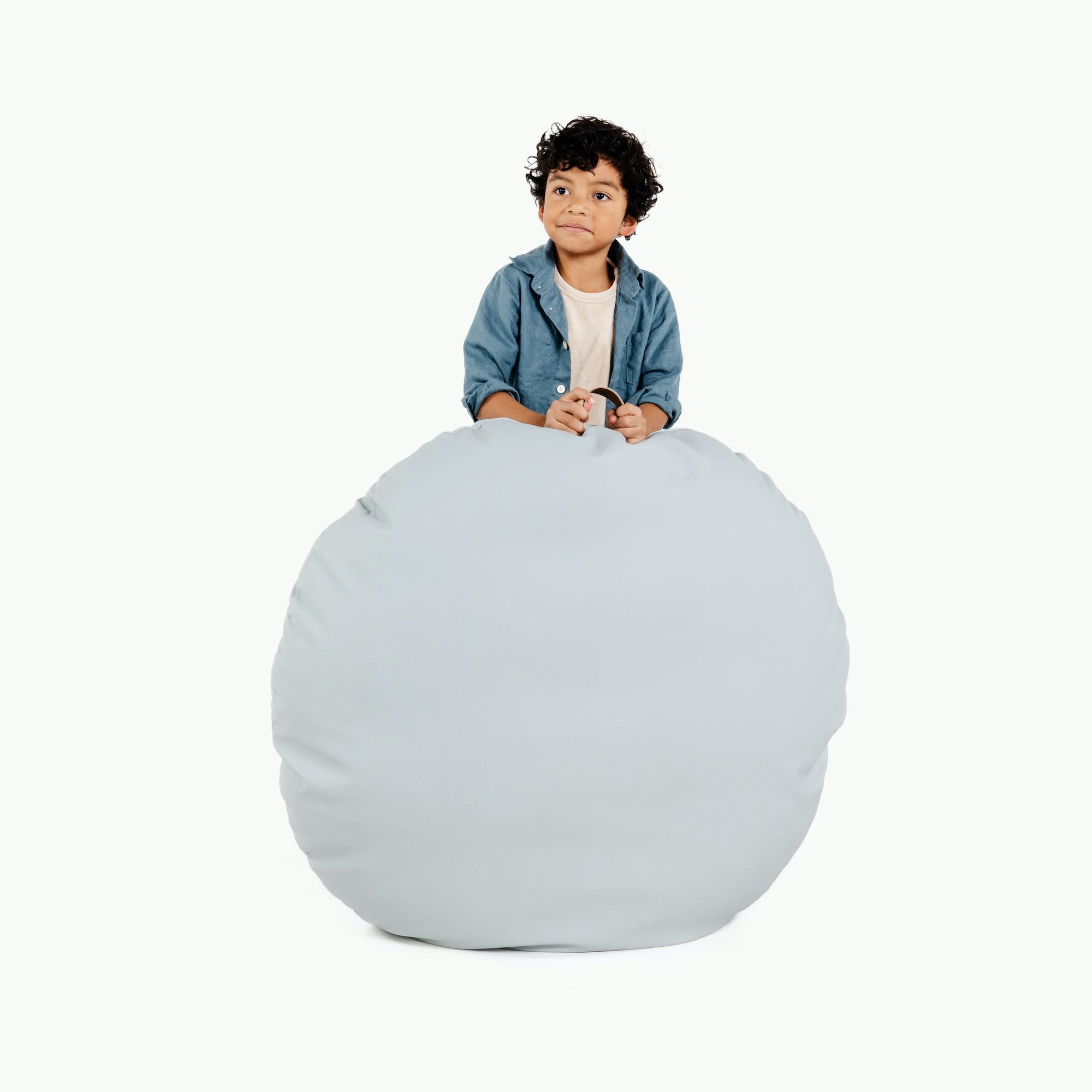 Dawn (on sale) / Circle@Kid holding the Dawn Circle Floor Cushion
