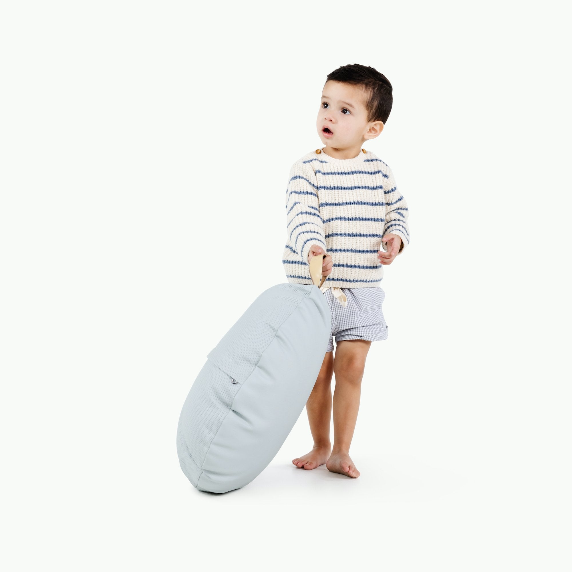 Dawn (on sale) / Circle@Kid holding the Dawn Circle Mini Floor Cushion