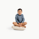 Dinosauria (on sale) / Square@little boy sitting on a mini cushion