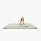 Flora@little girl sitting on padded mat