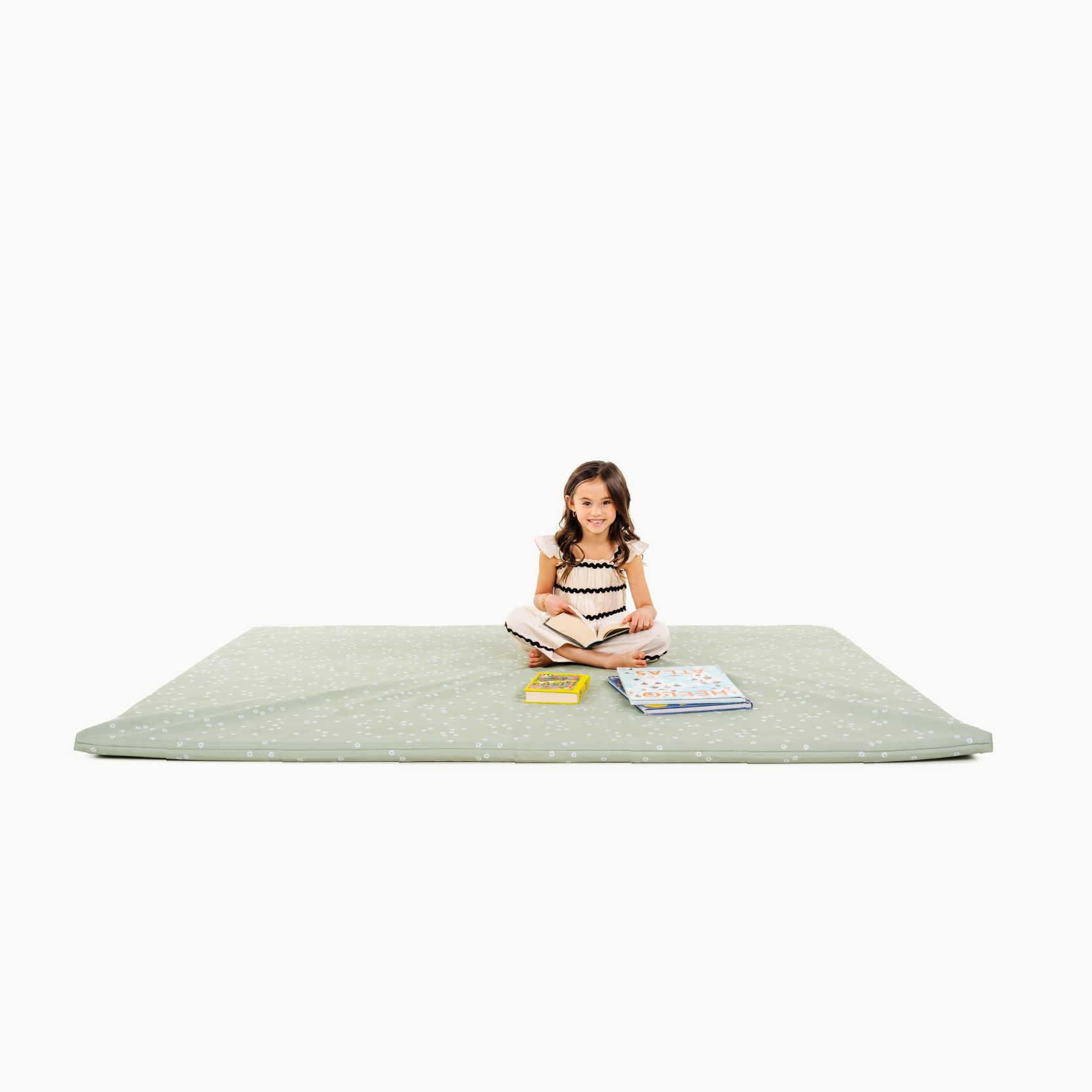 Flora@little girl sitting on padded mat