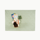 Flora@overhead of little girl sitting on padded mat