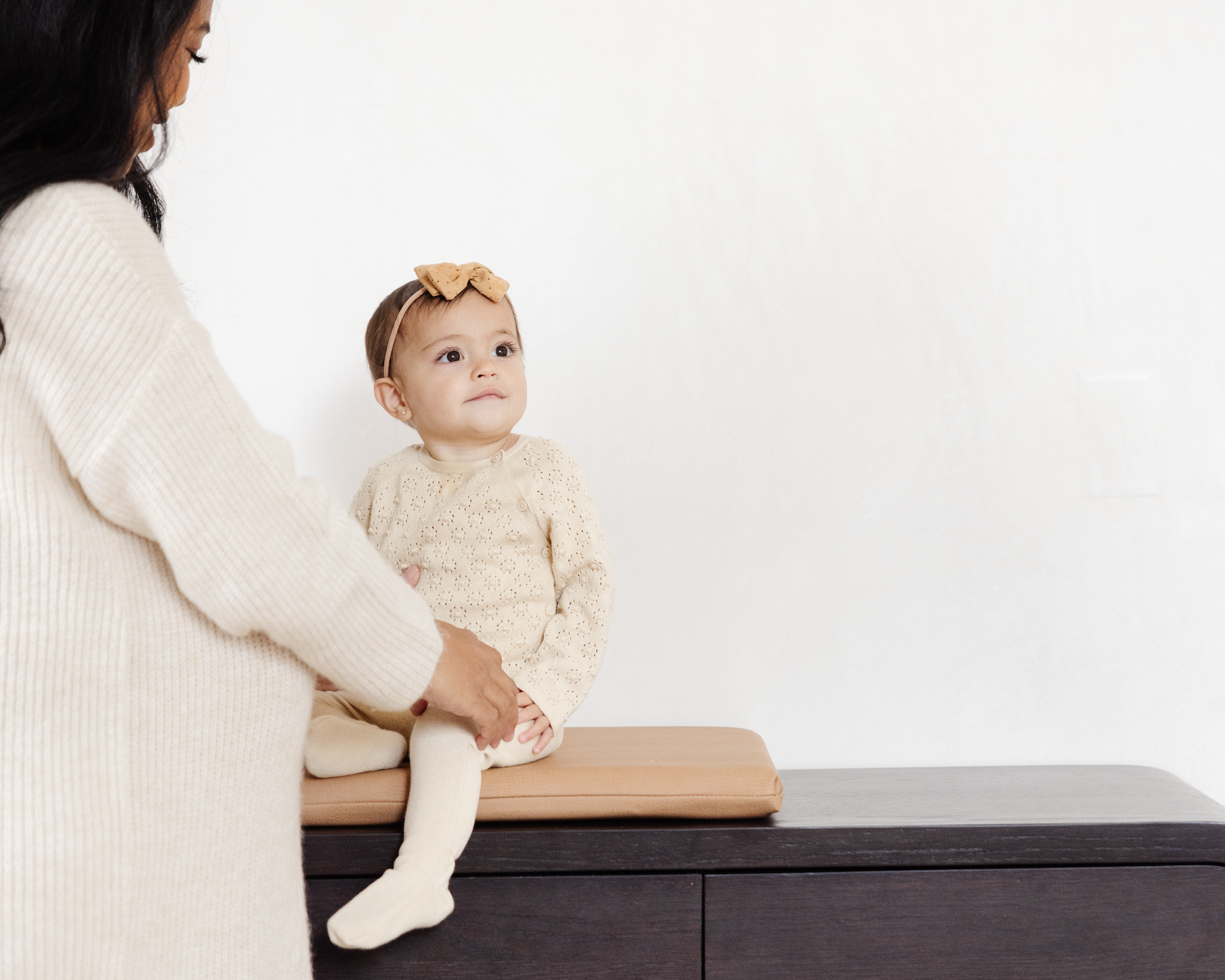 Baby sitting on changing table in Terra Padded Micro+