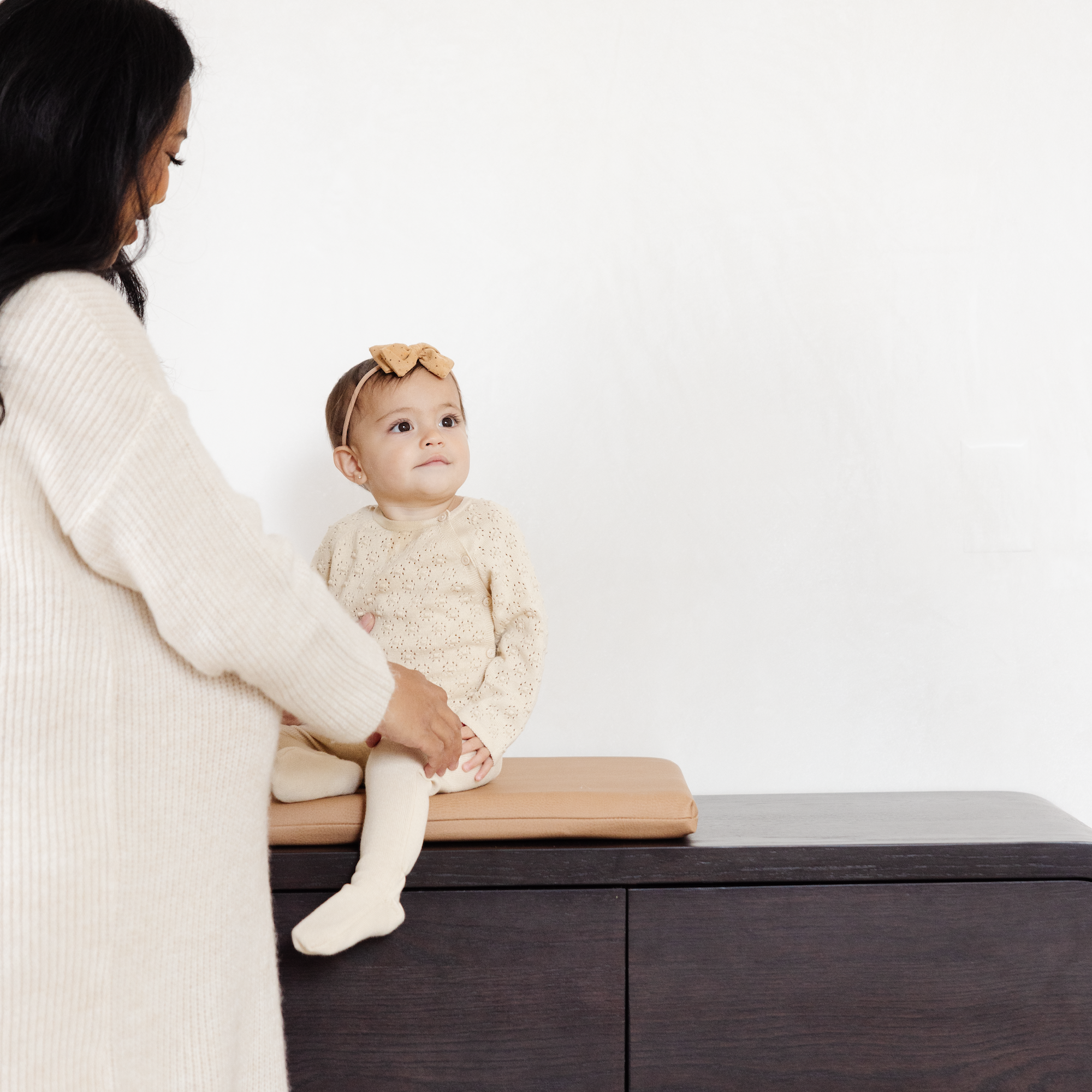 Baby sitting on changing table in Terra Padded Micro+