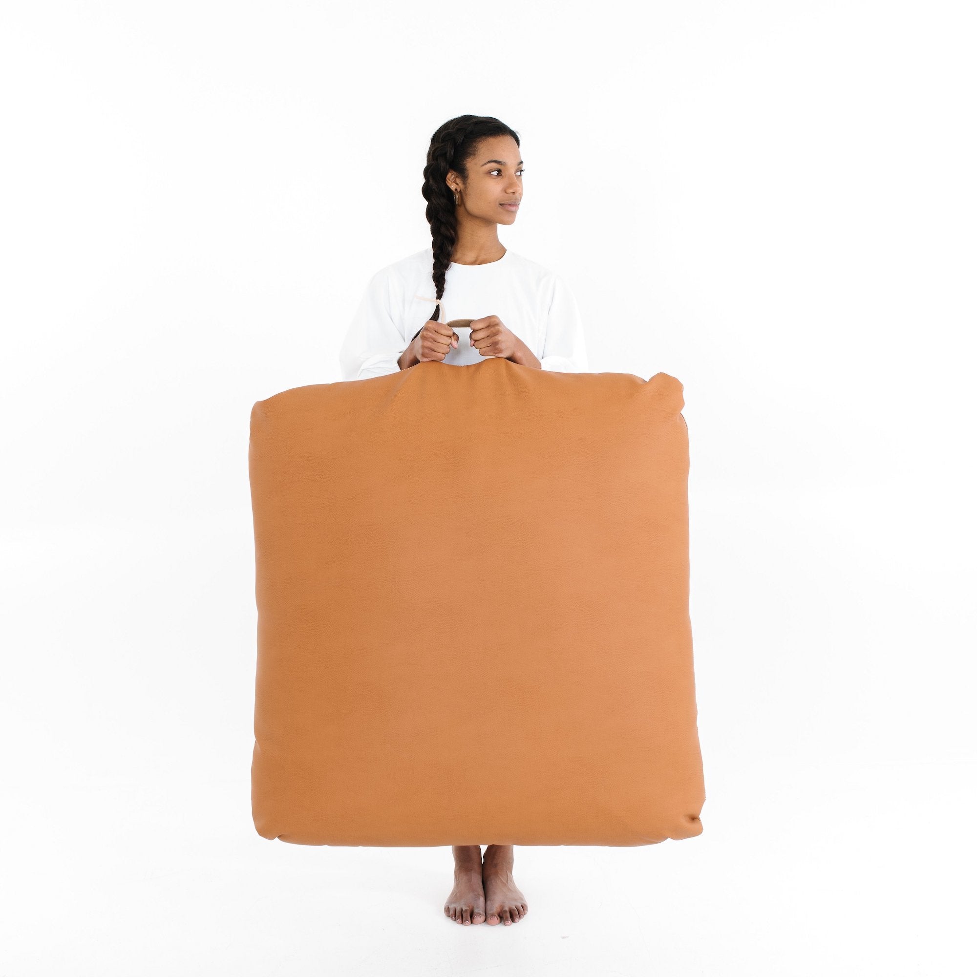 Ginger (on sale) / Square@Woman holding the Ginger Square Floor Cushion