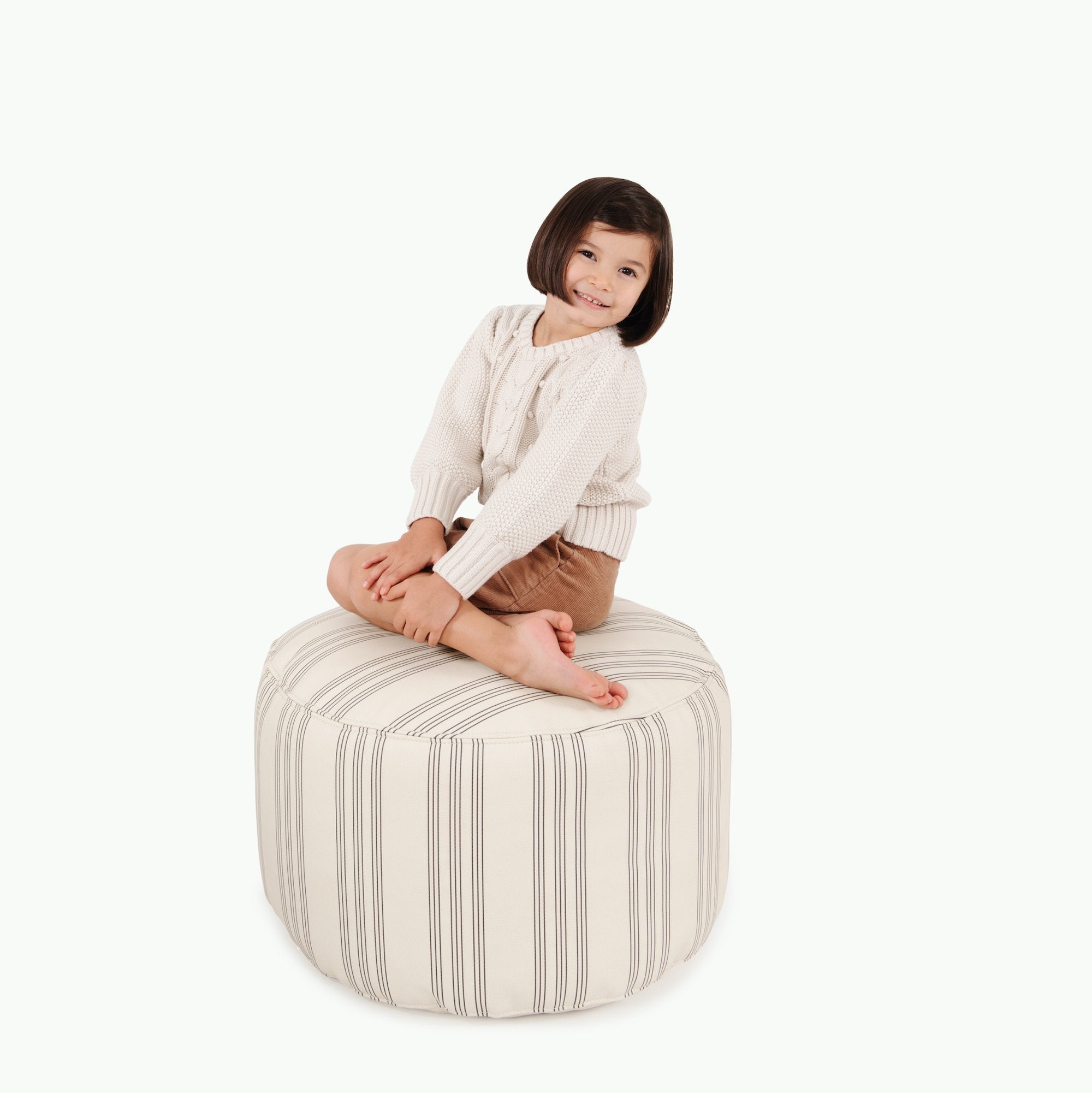 Pencil Stripe (on sale)@Kid sitting on the Pencil Stripe Circle Pouf
