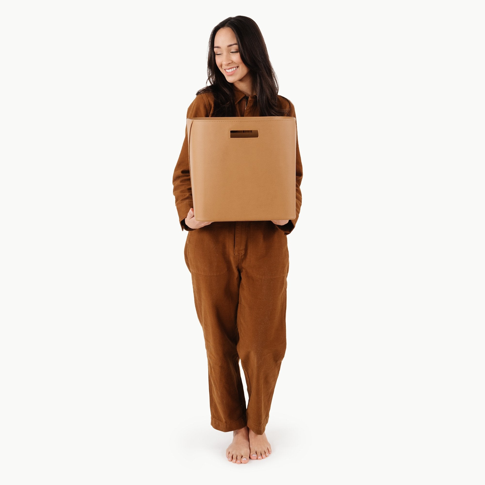 Camel@woman holding medium storage bin