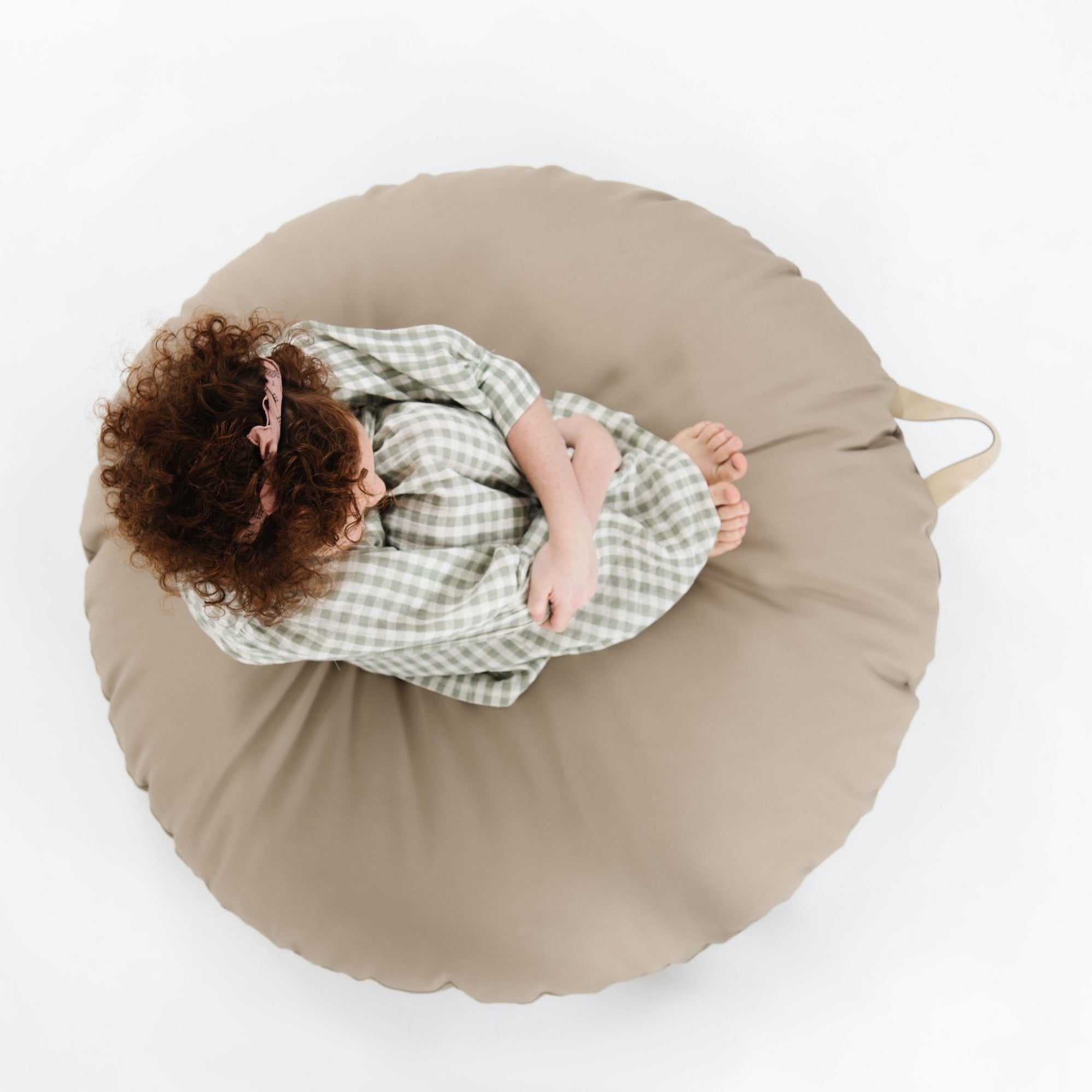 Ember (on sale) / Circle@Overhead of kid sitting on the Ember Circle Floor Cushion