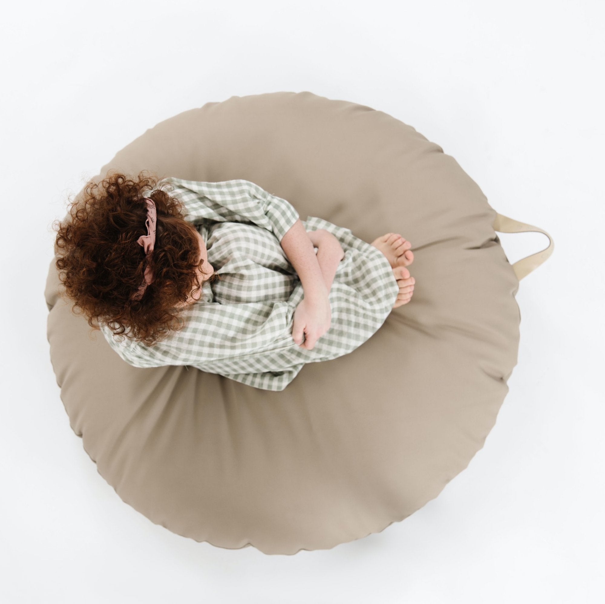 Ember (on sale) / Circle@Overhead of kid sitting on the Ember Circle Floor Cushion