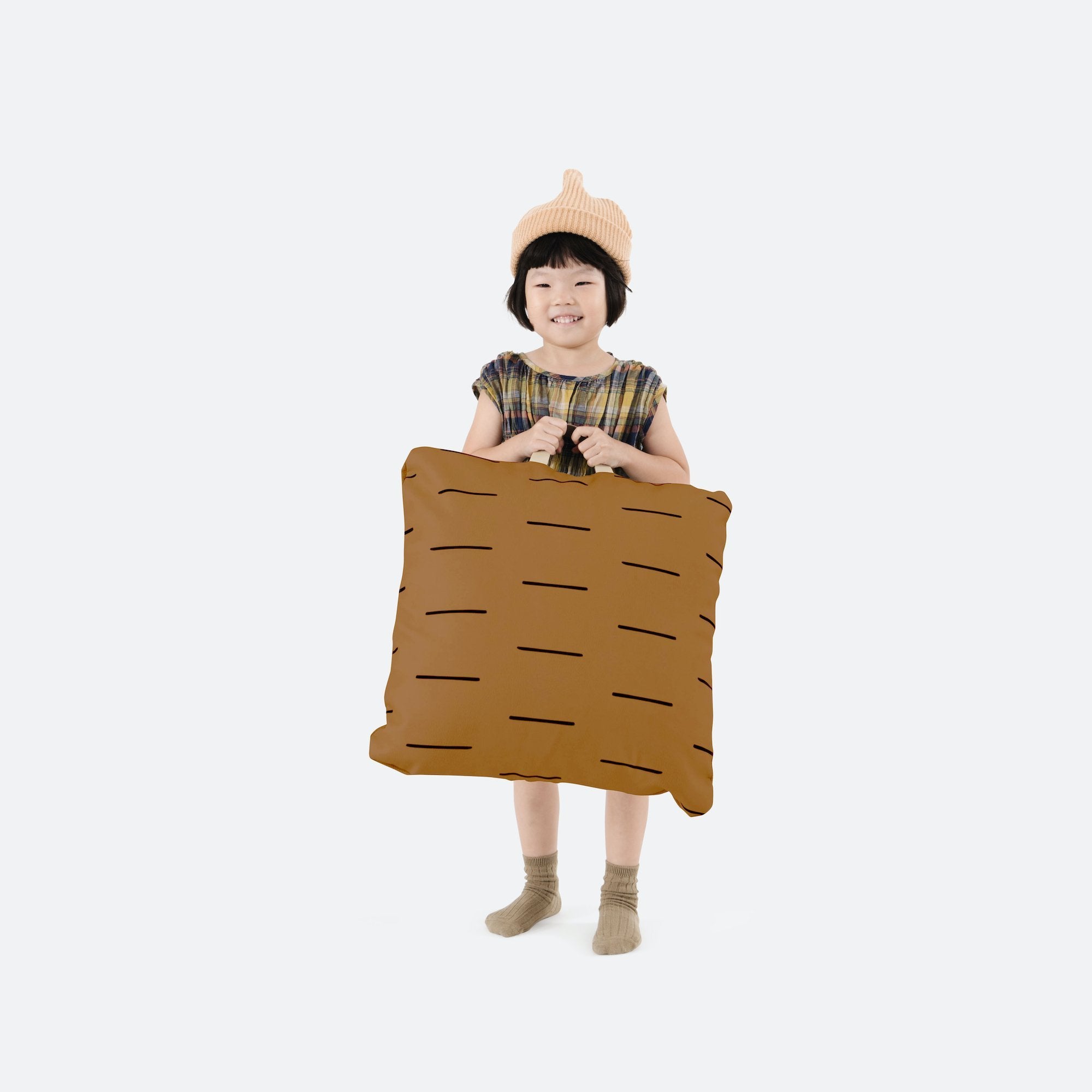 Camel Dash (on sale) / Square@Kid holding the Camel Dash Square Mini Floor Cushion