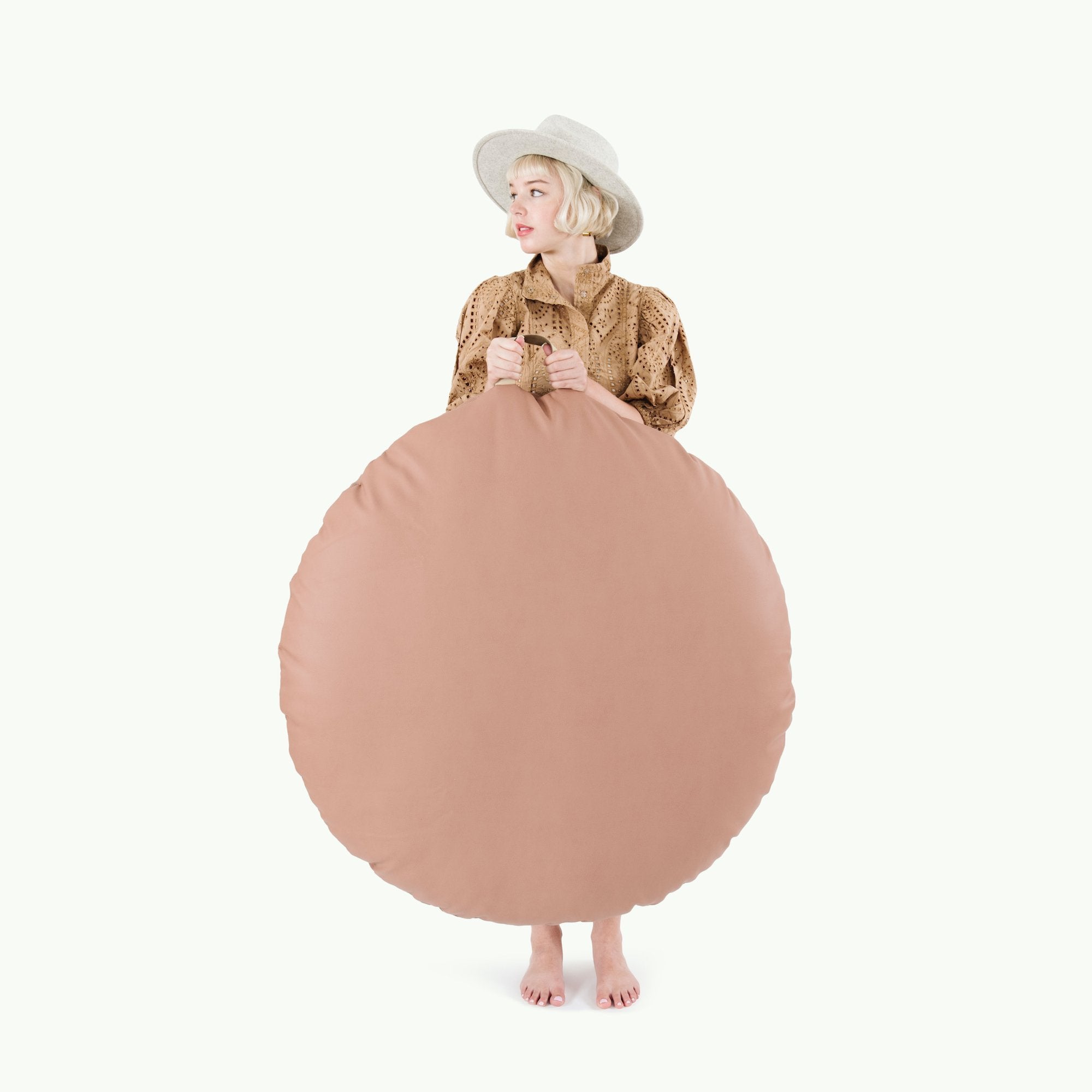 Sienna (on sale) / Circle@Woman holding the Sienna Circle Floor Cushion