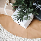 Camel (on sale)@close up of camel tree skirt under christmas tree with presents on top