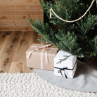 Pewter (on sale)@pewter tree skirt under christmas tree with presents on top