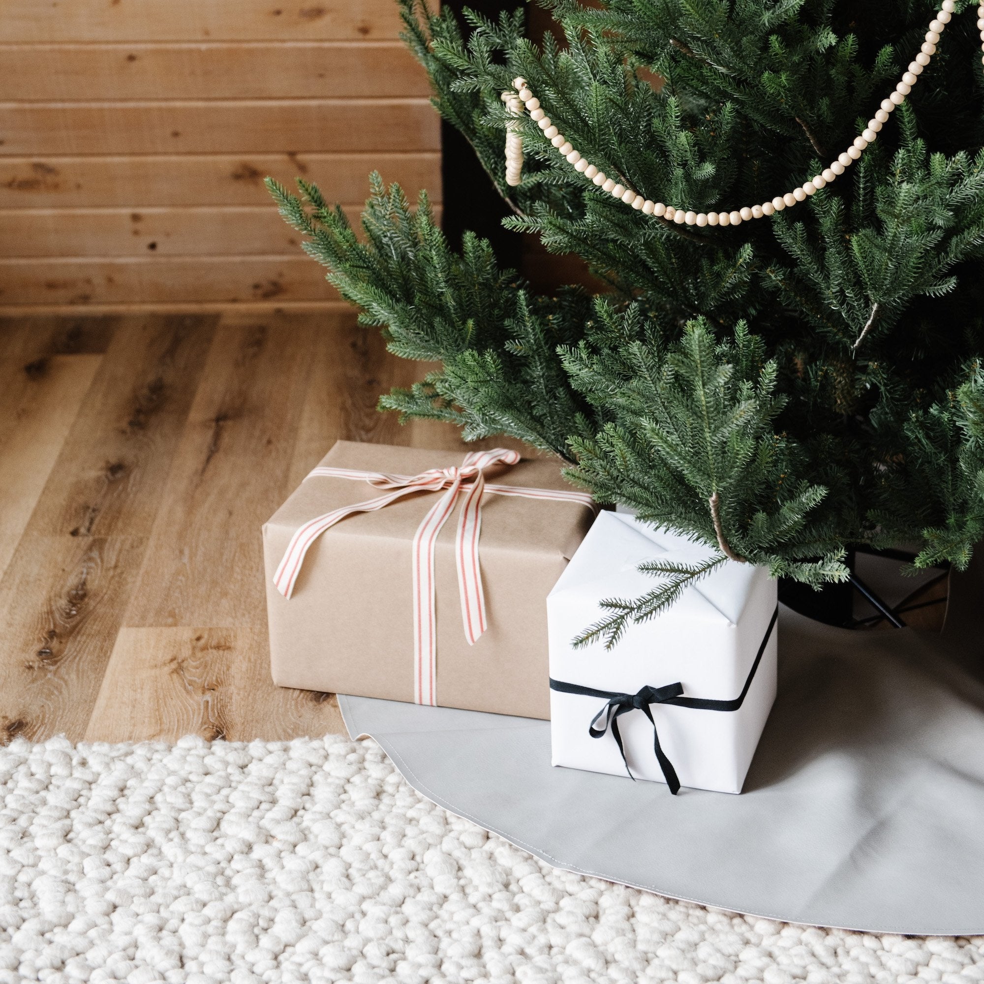 Pewter (on sale)@pewter tree skirt under christmas tree with presents on top