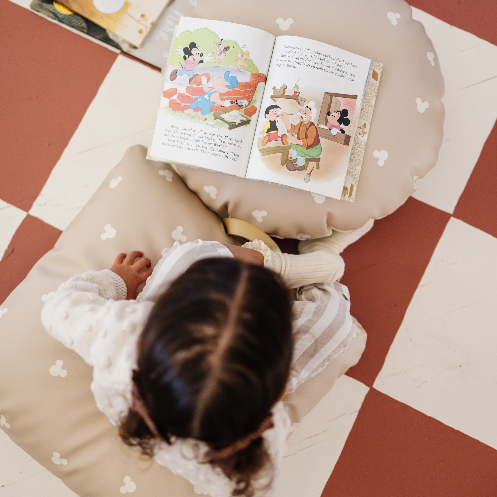 Mickey Mouse (on sale) / Circle@Overhead of kid reading books on the Mickey Mouse Mini Floor Cushions