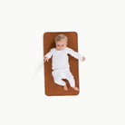Ginger (on sale)@Overhead of baby laying on the Ginger Micro+ Mat