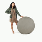Grove (on sale) / Circle@Woman holding up the Grove Floor Cushion