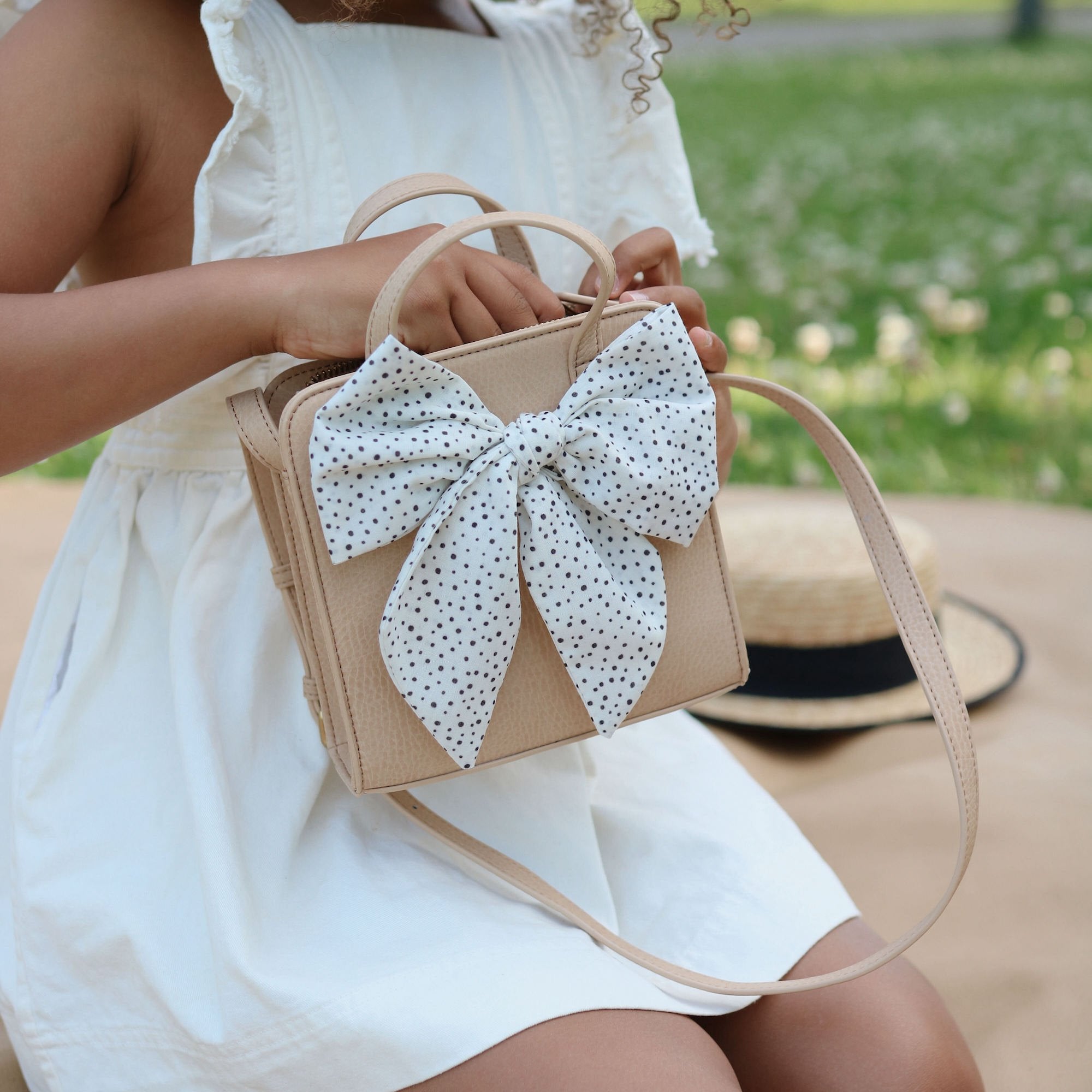 Untanned@Little girl outside looking inside the Untanned Children's Purse